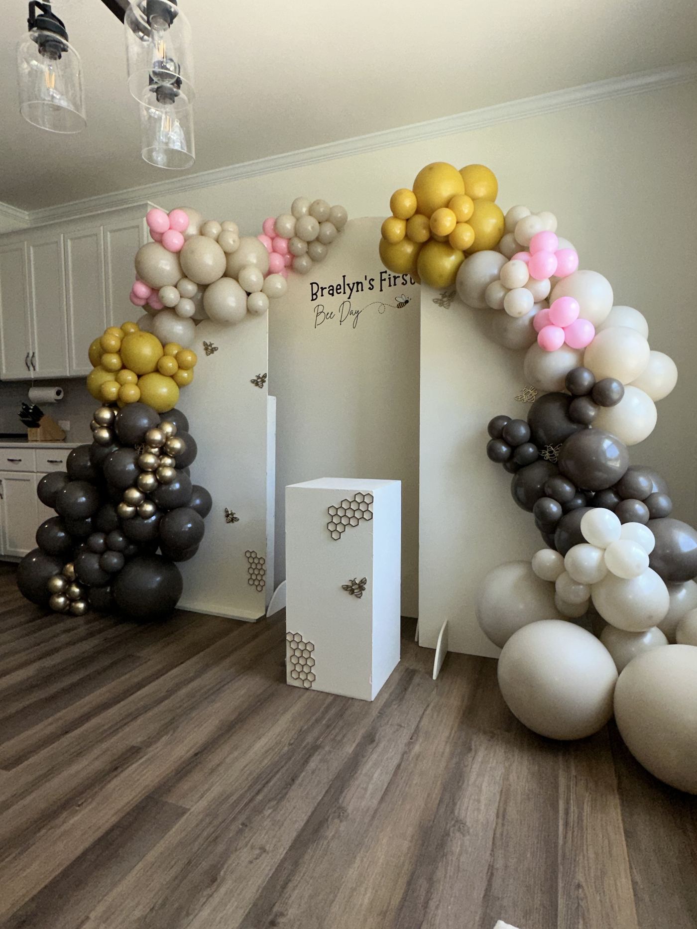 Gold, pink, and black balloon arch for Braelyn's first birthday